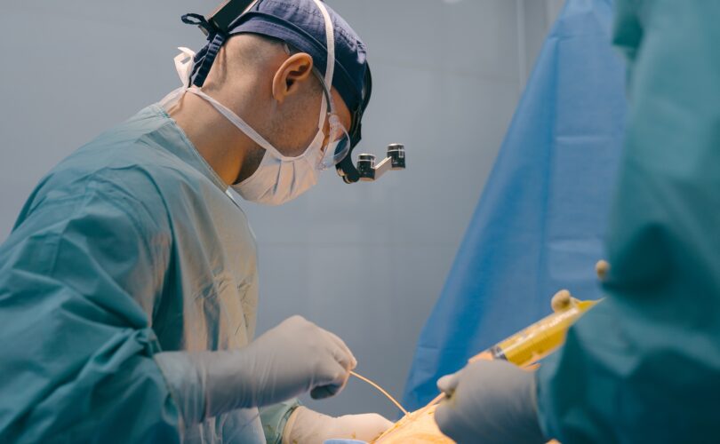 Doctor man physician surgeon perform plastic surgery liposuction surgical laparoscopic abdominal
